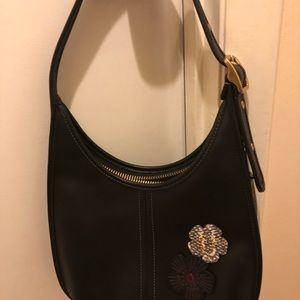 Small Coach Hobo bag with floral embossing.